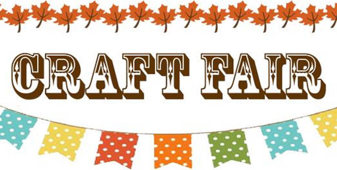 Craft Fair sign. Brown Maple leaves are strung across the top of the image. Colorful flags are hanging on a line below.